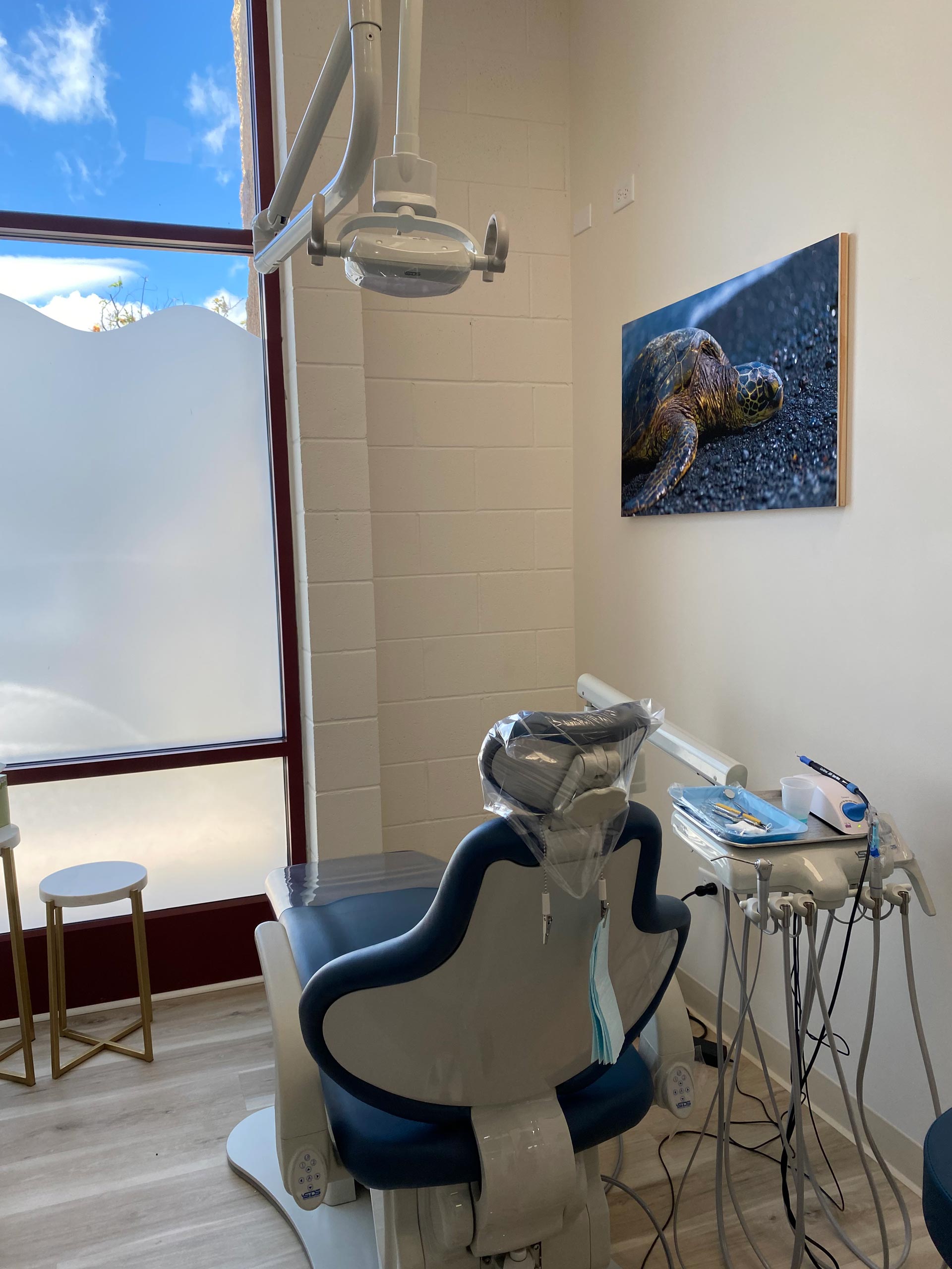 A dental office with a blue chair and equipment.